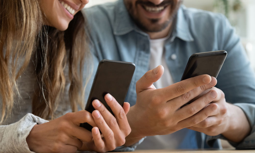 Instant Church Directory photo image showing a happy couple viewing their directory on their cell phones